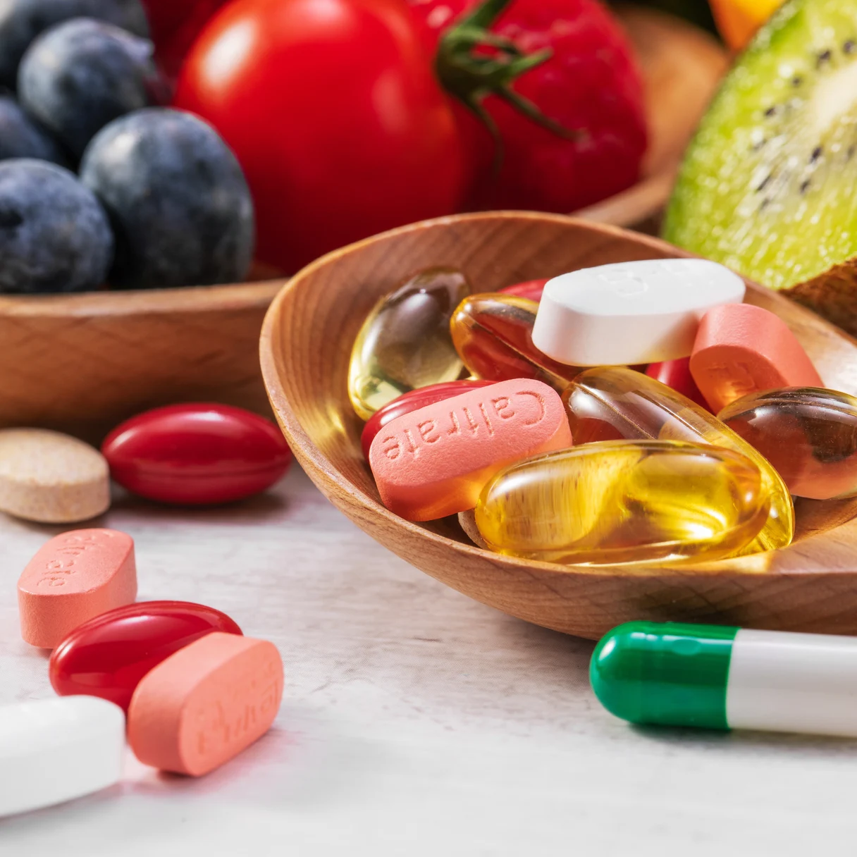 Golden omega-3 softgels in a wooden bowl